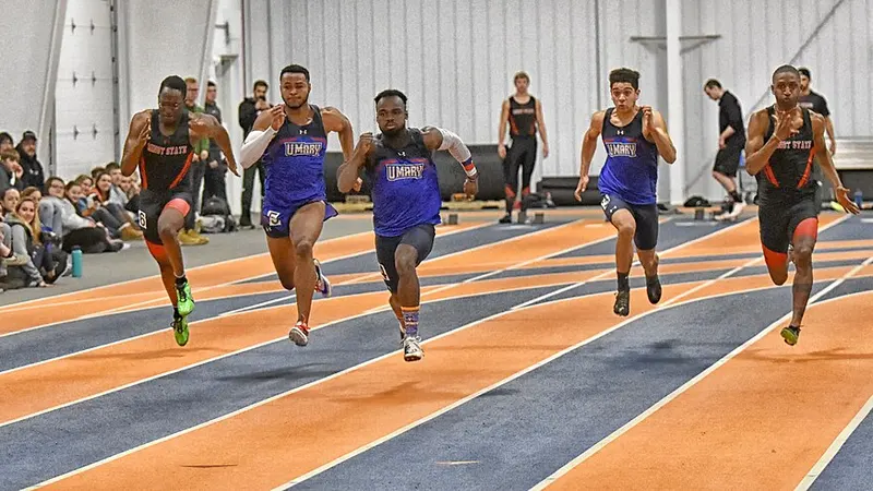 Sprinters racing on an indoor athletics track