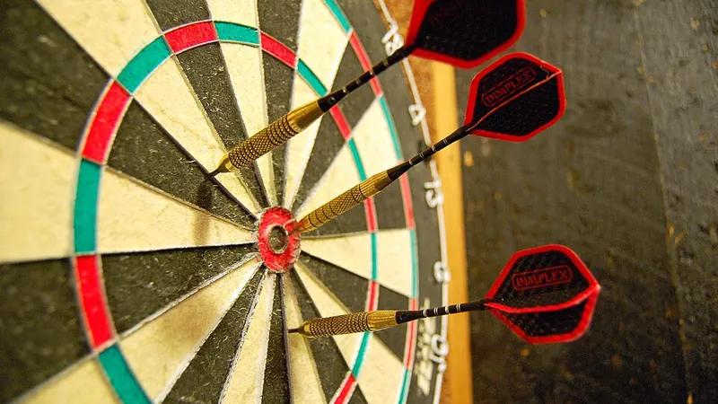 Darts embedded in a numbered dartboard