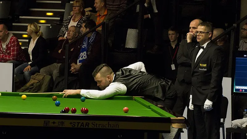 Snooker player lining up a shot on a green table