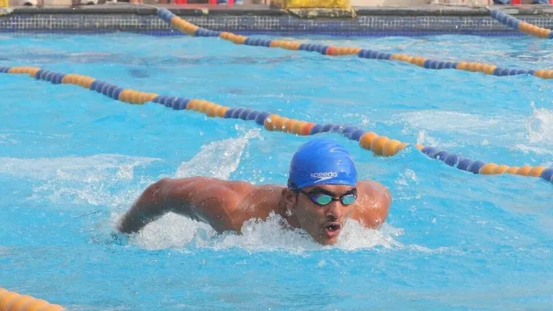 Competitive swimmer in a marked swimming pool lane